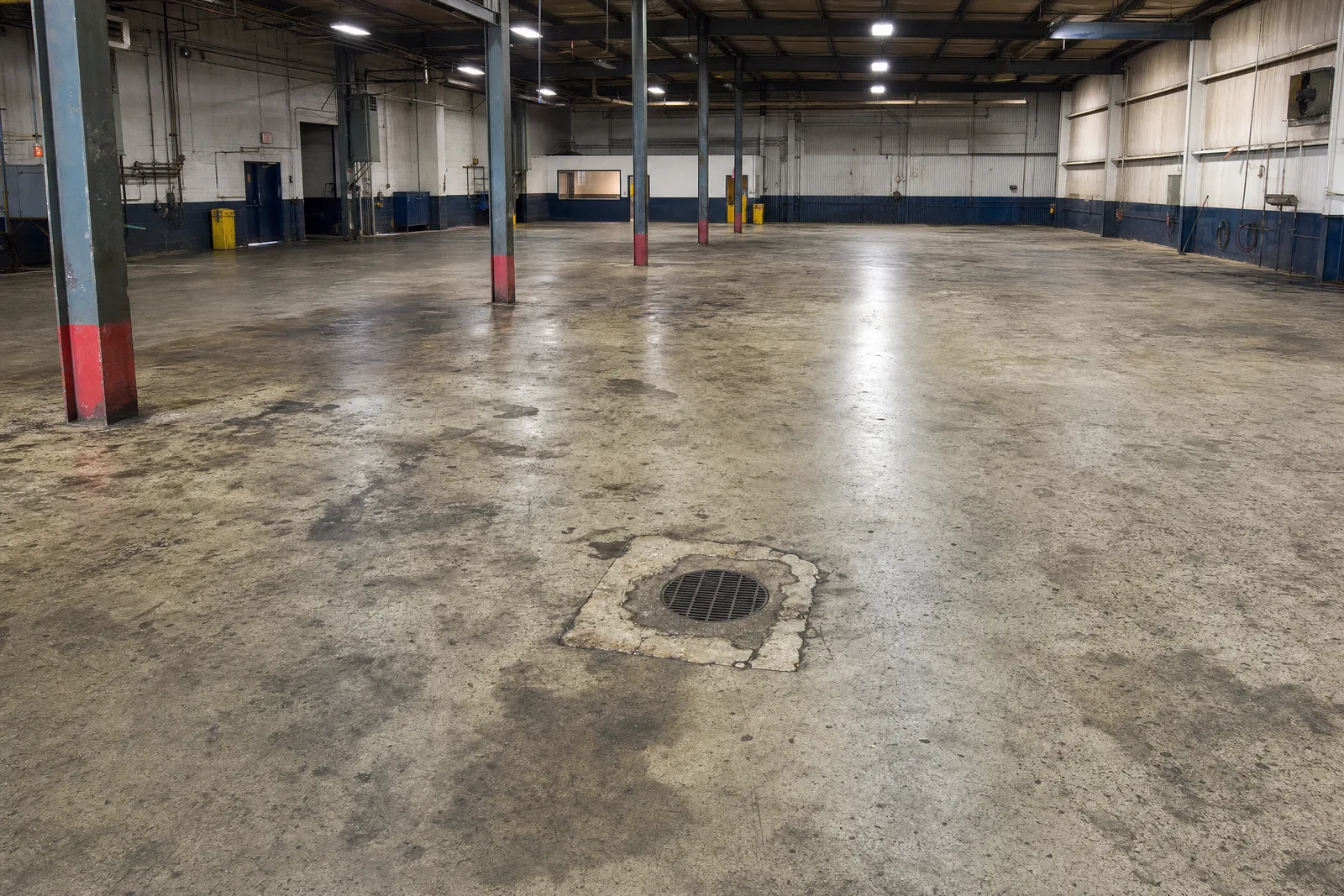 Illustrative oil-stained shop floor before coating