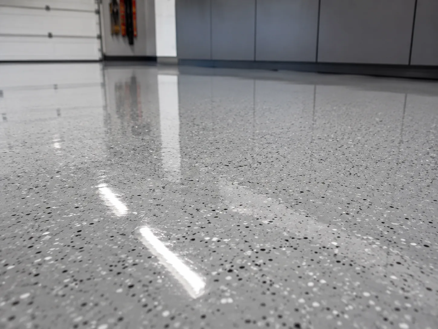 Illustrative high-gloss clear topcoat reflection on a coated garage floor