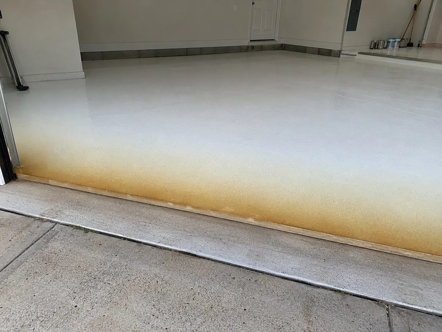 Illustrative UV ambering on a coating near a sunlit garage door opening