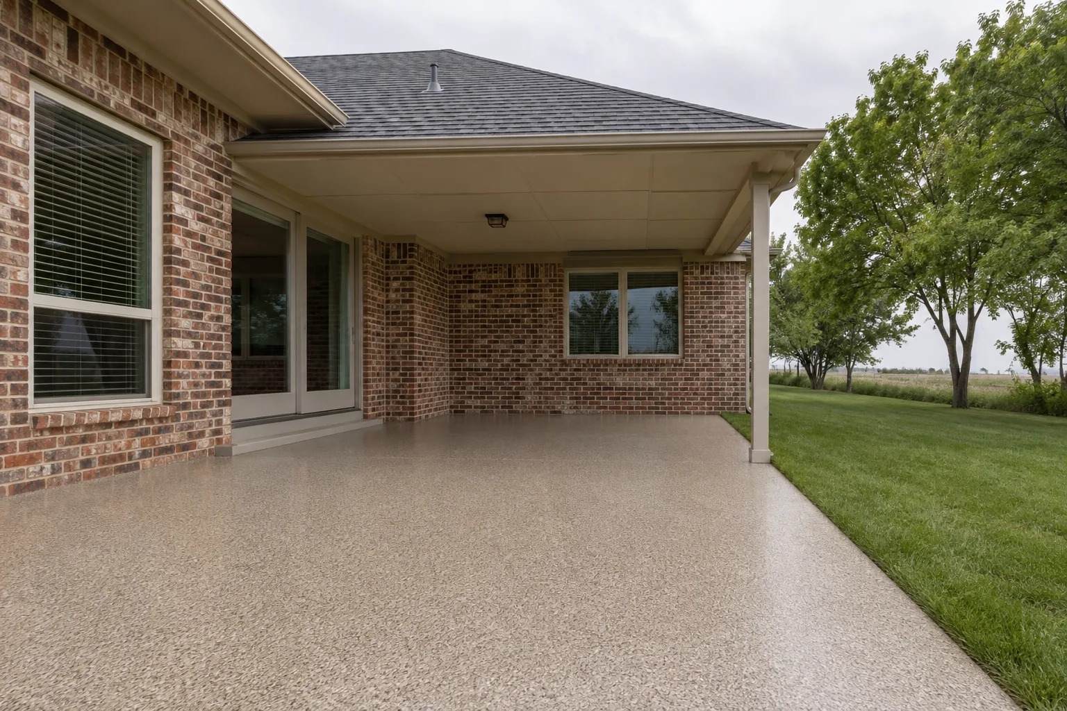 Illustrative coated patio surface in a light tan exterior finish